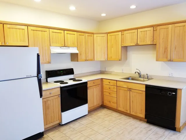 a kitchen with a white cabinets and white appliances
