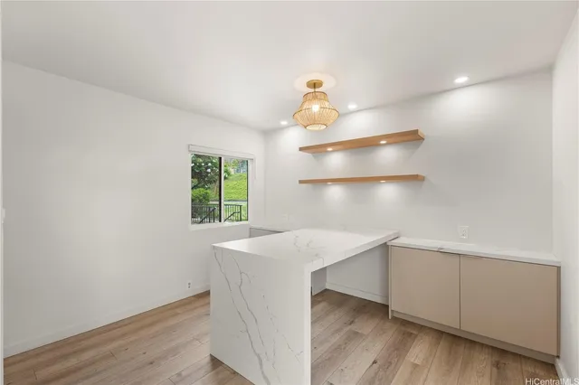 a kitchen with a stove and wooden floor