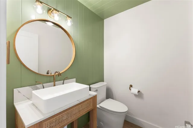 a bathroom with a sink a mirror and a toilet