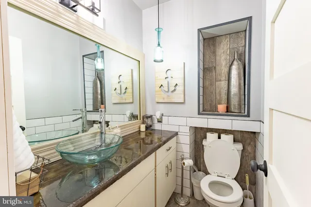 a kitchen with stainless steel appliances kitchen island granite countertop a refrigerator and a stove top oven