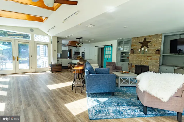 a kitchen with stainless steel appliances granite countertop a sink a stove and a microwave