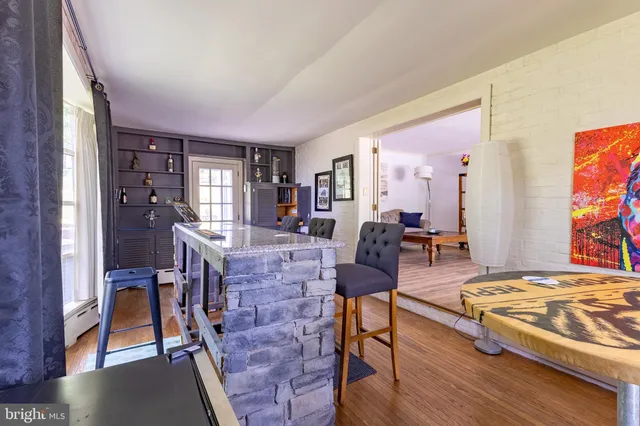 a kitchen with granite countertop wooden cabinets a sink a window and stainless steel appliances