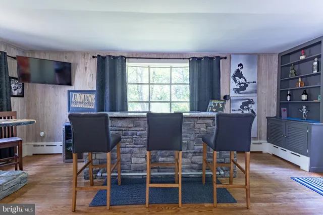 a living room with furniture a flat screen tv and a large window