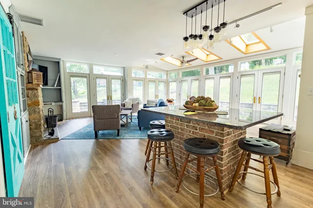 a bedroom with a bed dresser and wooden floor