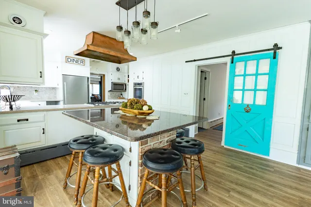 a bathroom with a sink mirror vanity and toilet