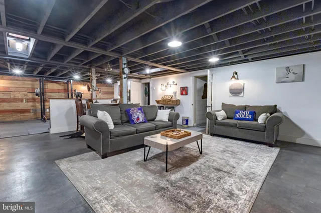 a bedroom with a bed and large window with wooden floor