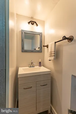 a spacious bathroom with a tub sink and mirror