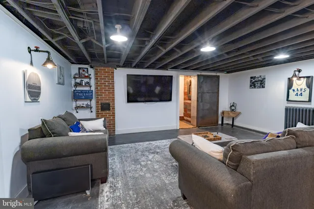 a living room with furniture a window and a chandelier