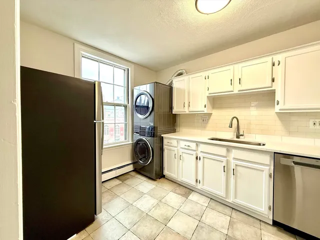 a kitchen with a refrigerator and a sink