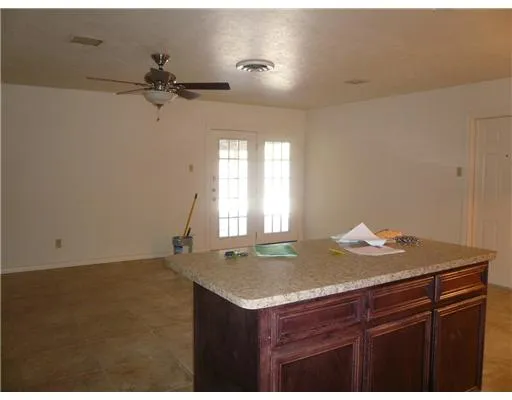 a bathroom with a granite countertop sink and window