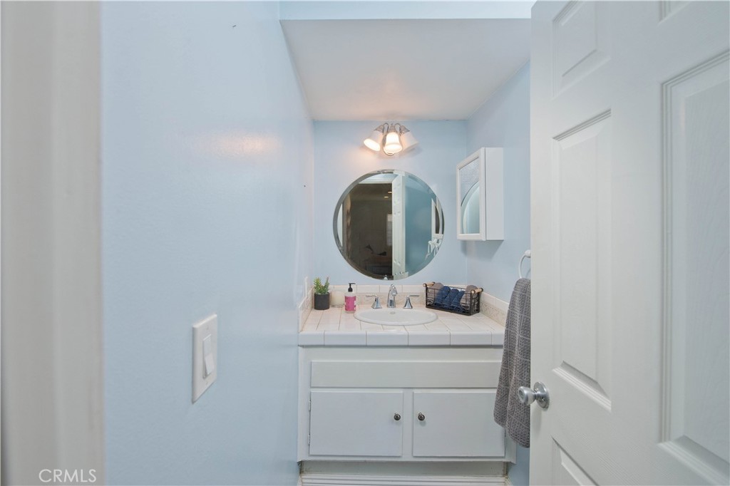 29262 Florabunda Road Canyon Country, CA 91387 - Photo 11 of 27 a bathroom with a sink vanity and a mirror