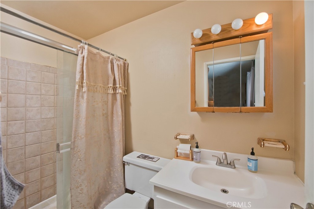 29262 Florabunda Road Canyon Country, CA 91387 - Photo 13 of 27 a bathroom with a sink mirror and a toilet