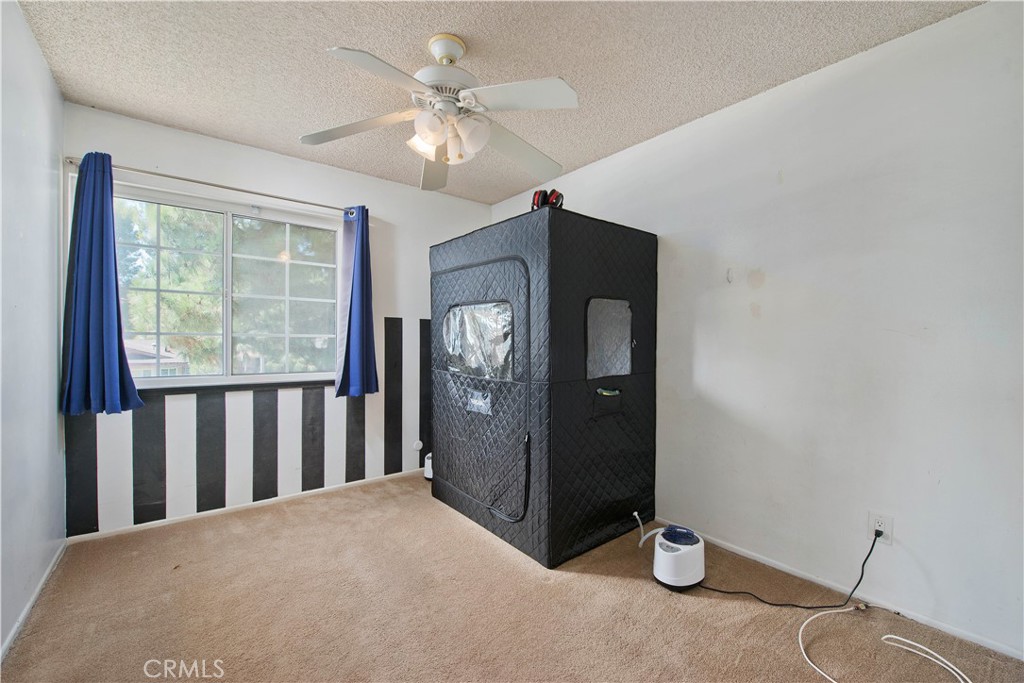 29262 Florabunda Road Canyon Country, CA 91387 - Photo 16 of 27 a view of a livingroom with a chandelier fan and windows