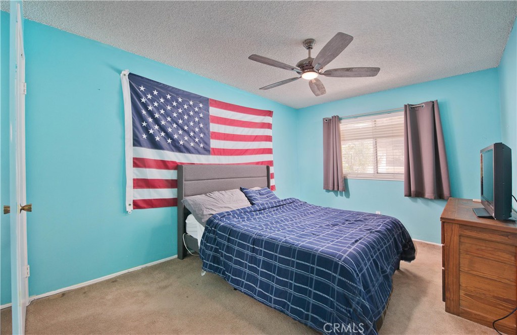 29262 Florabunda Road Canyon Country, CA 91387 - Photo 17 of 27 a bedroom with a bed and a chandelier