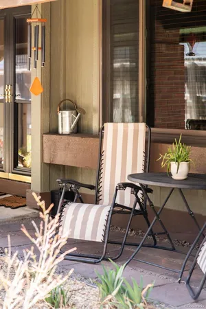 a view of a patio with table and chairs and potted plants