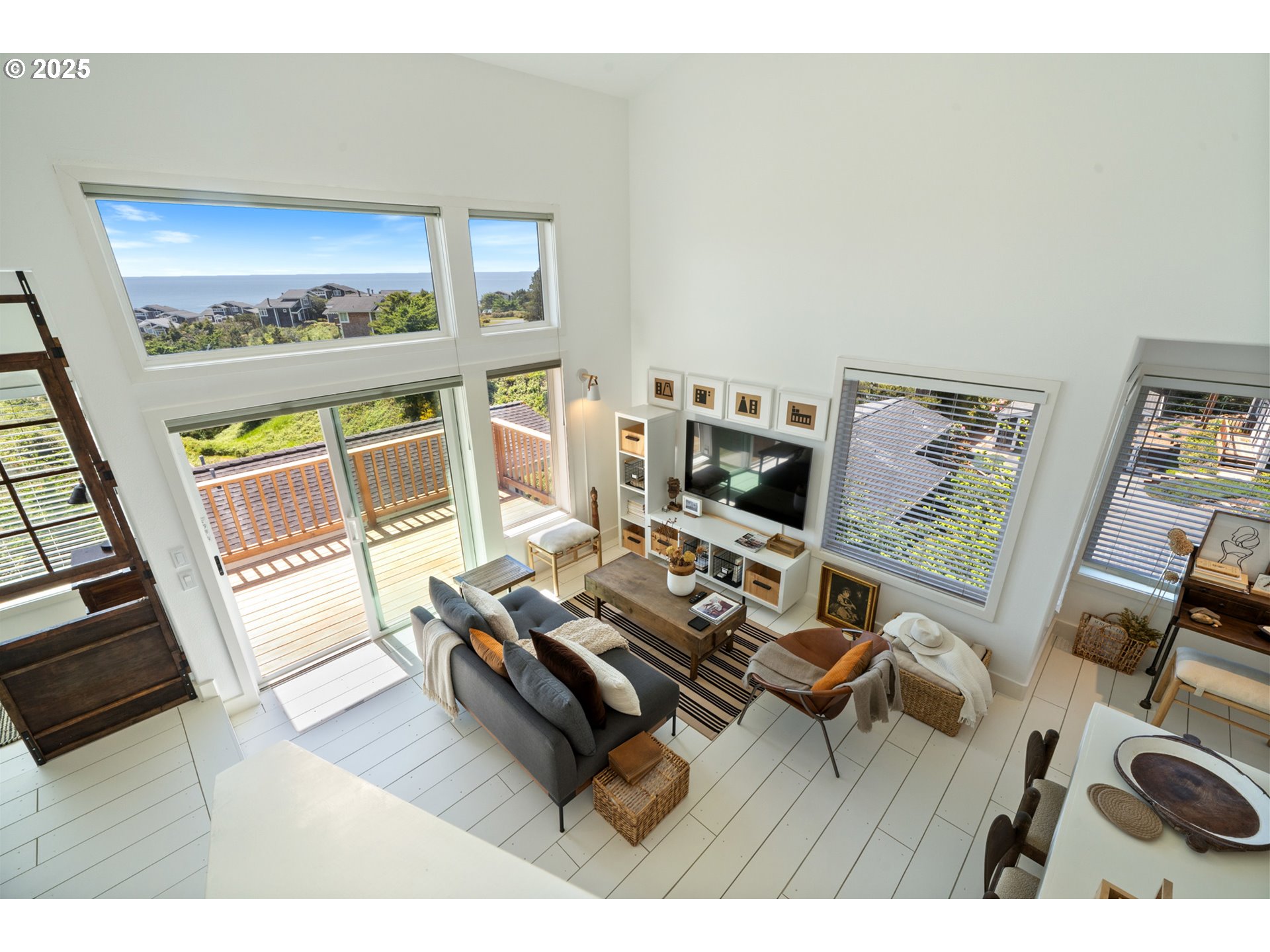 505 Capes Drive, Unit 9 Oceanside, OR 97141 - Photo 12 of 45 a living room with furniture and a flat screen tv