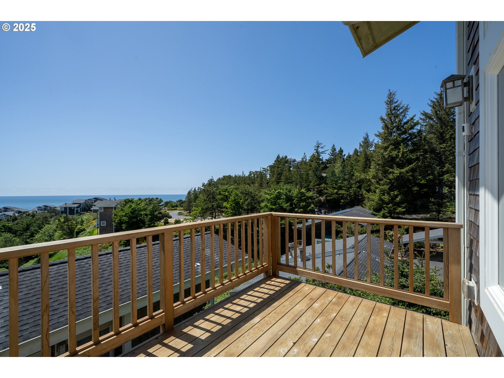 505 Capes Drive, Unit 9 Oceanside, OR 97141 - Photo 16 of 45 a view of balcony with wooden floor and fence