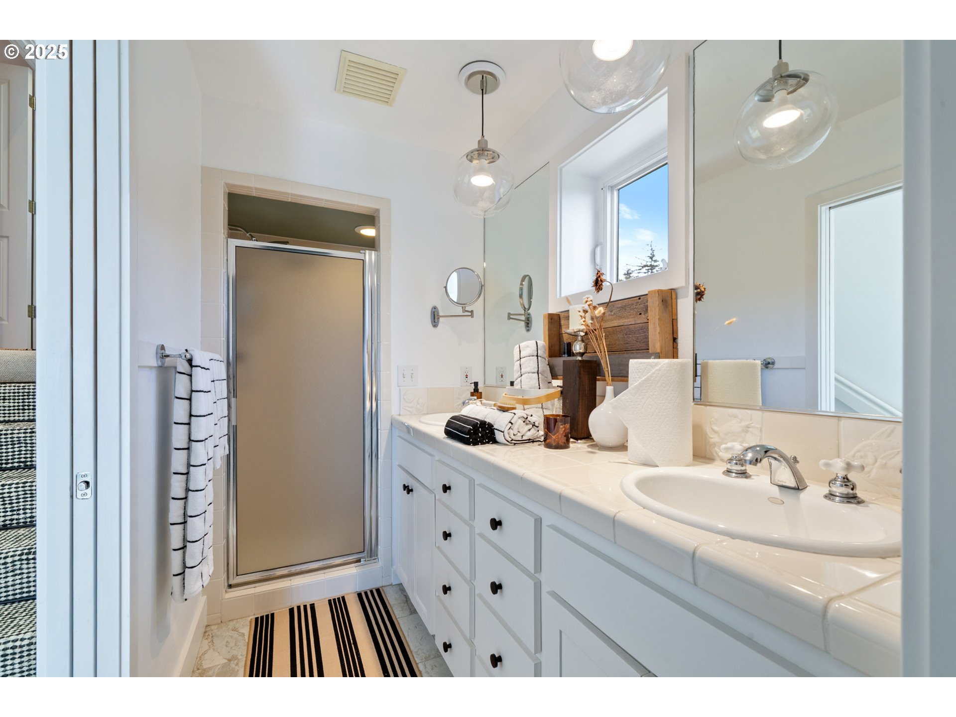 505 Capes Drive, Unit 9 Oceanside, OR 97141 - Photo 18 of 45 a bathroom with a double vanity sink mirror and shower