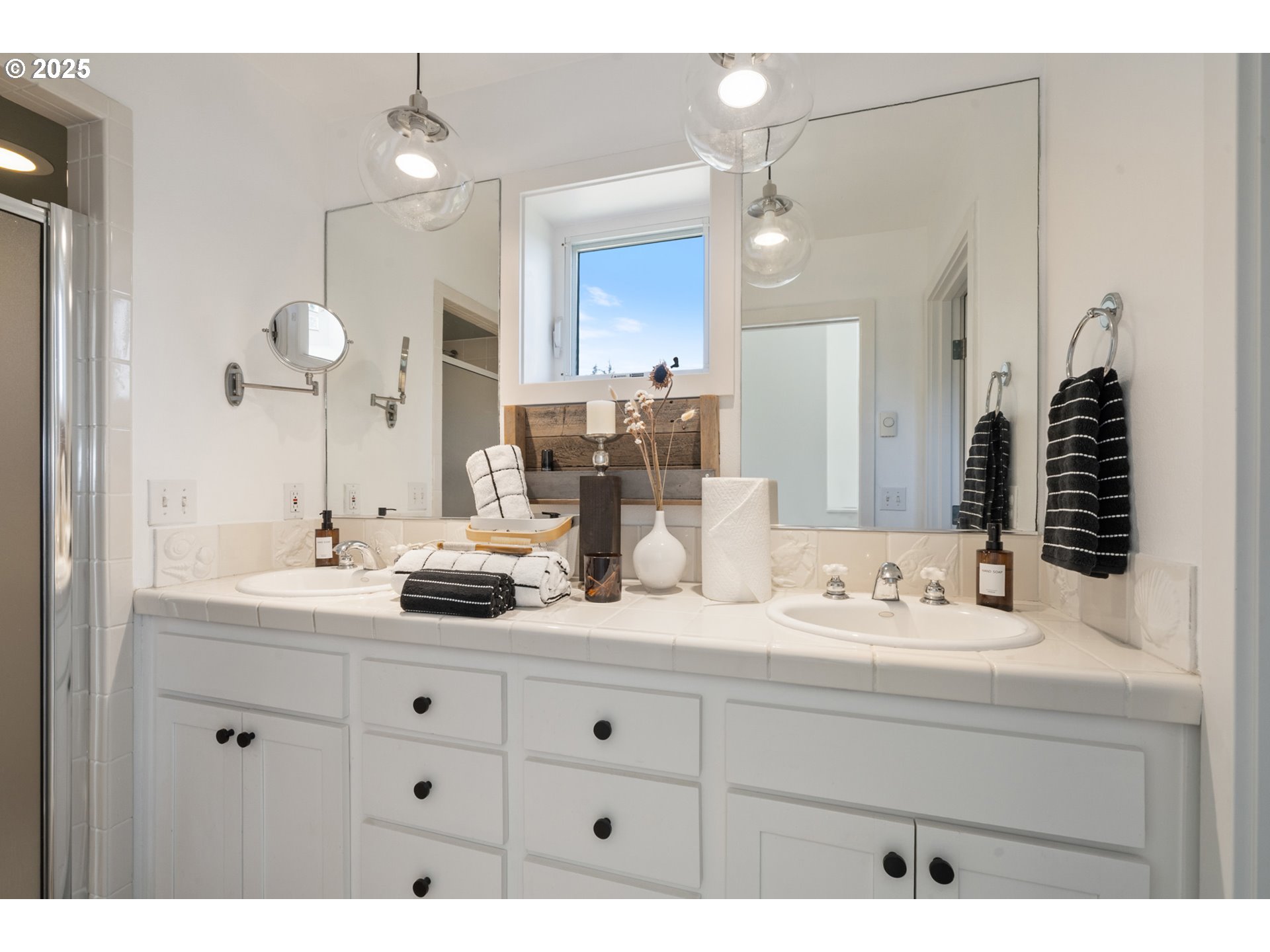505 Capes Drive, Unit 9 Oceanside, OR 97141 - Photo 19 of 45 a bathroom with a sink double vanity and a mirror