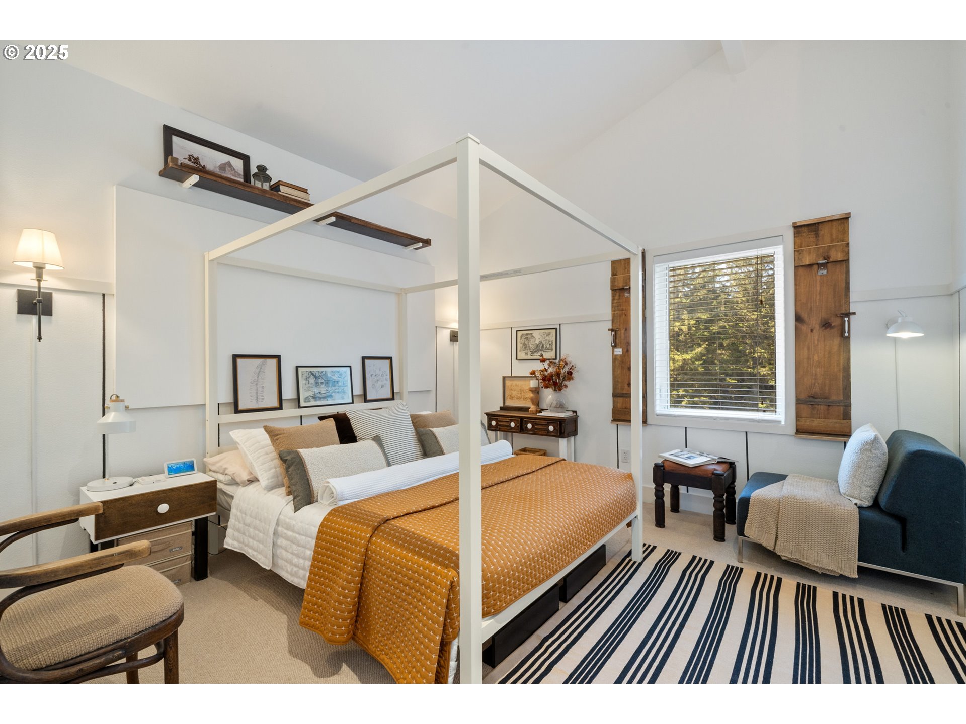 505 Capes Drive, Unit 9 Oceanside, OR 97141 - Photo 21 of 45 a bedroom with furniture and a large window