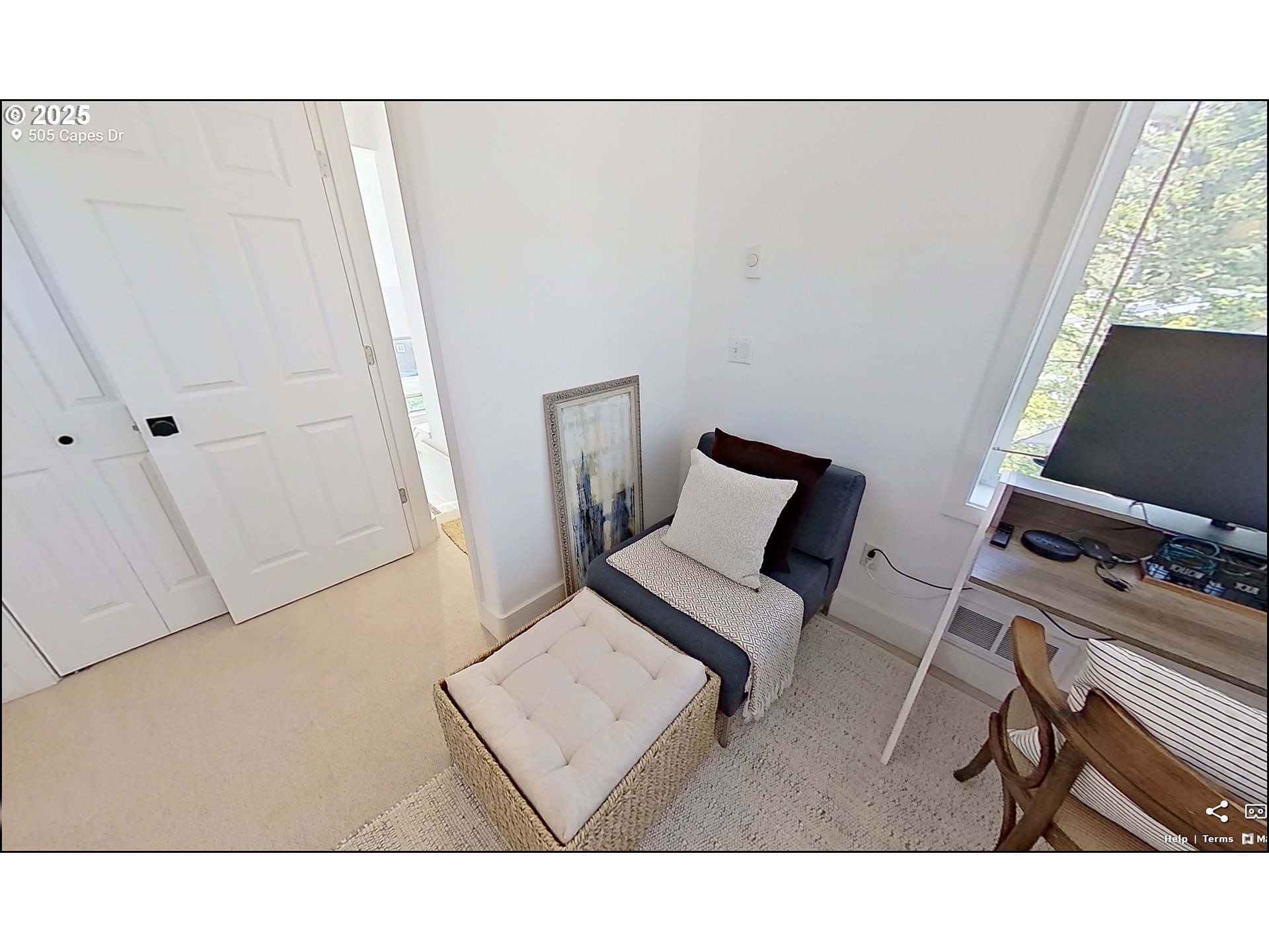 505 Capes Drive, Unit 9 Oceanside, OR 97141 - Photo 29 of 45 a living room with a couch and a flat screen tv