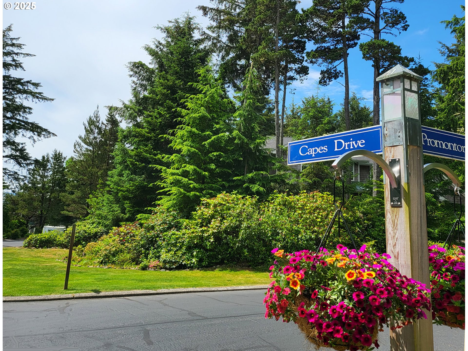 505 Capes Drive, Unit 9 Oceanside, OR 97141 - Photo 33 of 45 a view of a sign board with flower in front of it