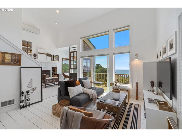 a living room with furniture a flat screen tv and a large window