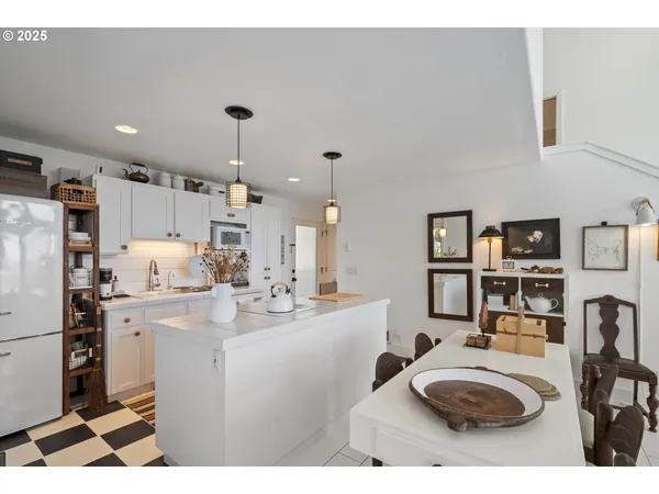 a kitchen with kitchen island a sink appliances and cabinets