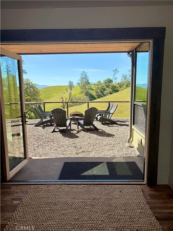 a living room with furniture and a view of kitchen