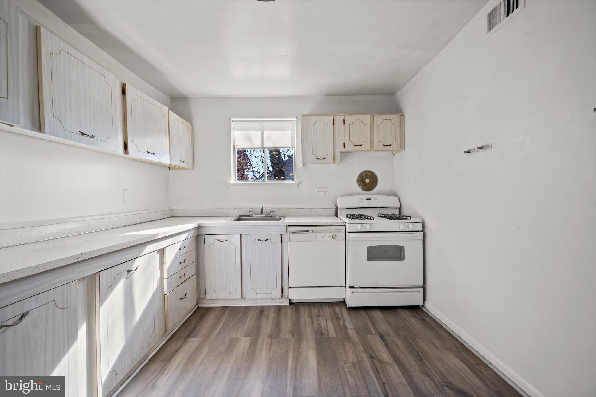 6511 Parsons Avenue Baltimore, MD 21215 - Photo 16 of 25 a kitchen with a stove cabinets and a sink