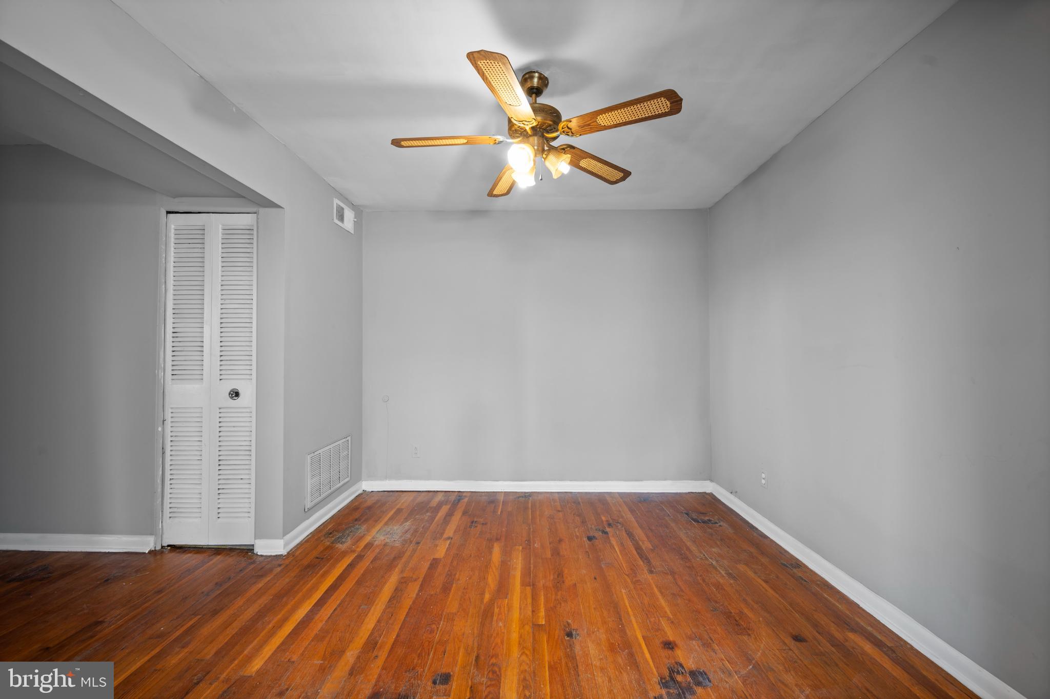 6511 Parsons Avenue Baltimore, MD 21215 - Photo 23 of 25 a view of an empty room with wooden floor and a ceiling fan