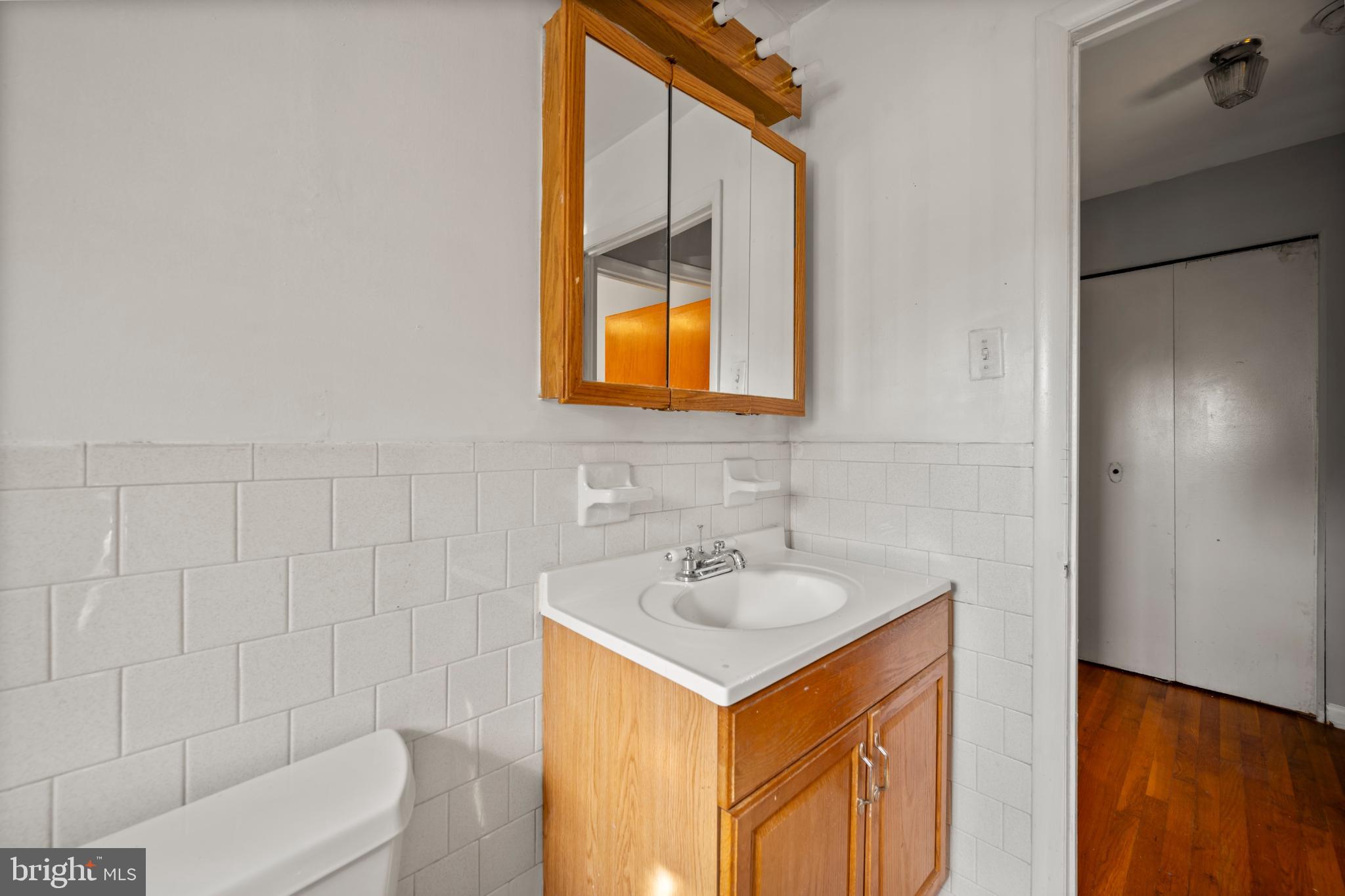 6511 Parsons Avenue Baltimore, MD 21215 - Photo 7 of 25 a bathroom with a sink and a mirror