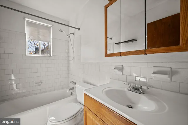 a bathroom with a sink a toilet and bathtub