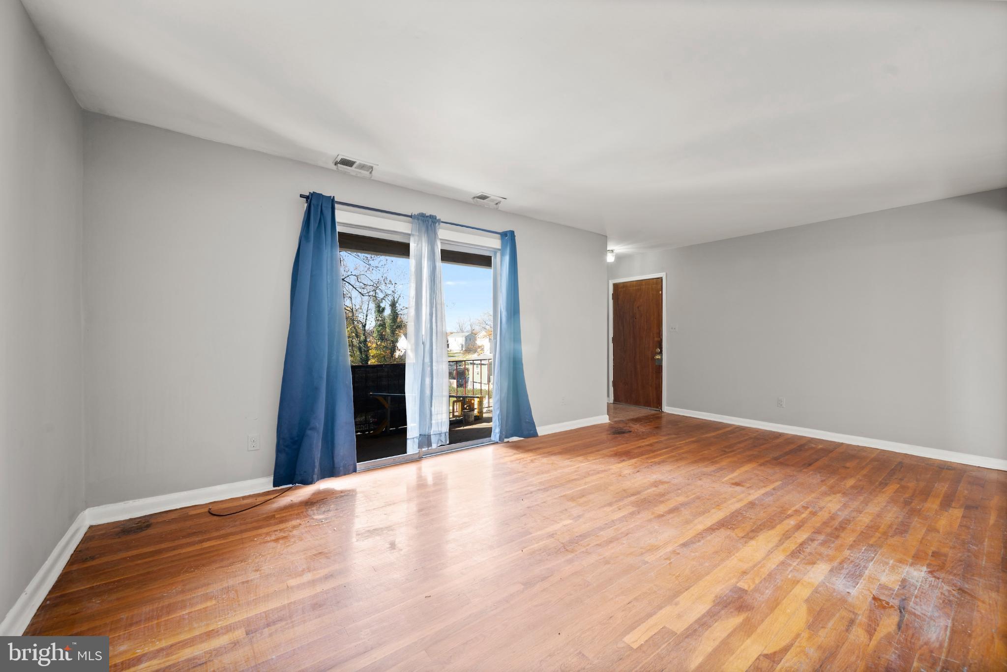 6511 Parsons Avenue Baltimore, MD 21215 - Photo 10 of 25 a view of an empty room with wooden floor and kitchen