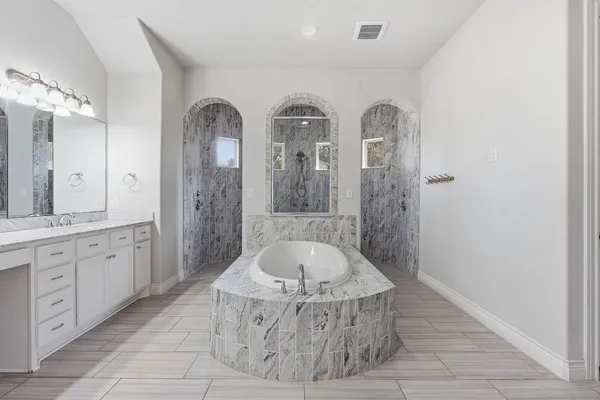 a bathroom with a tub and shower