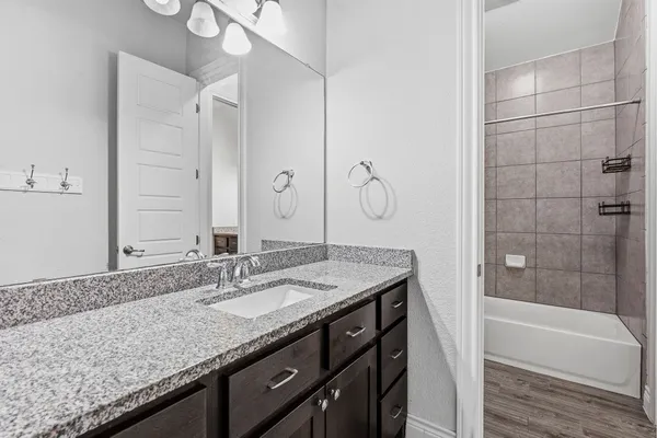 a white toilet sitting next to a bathroom sink