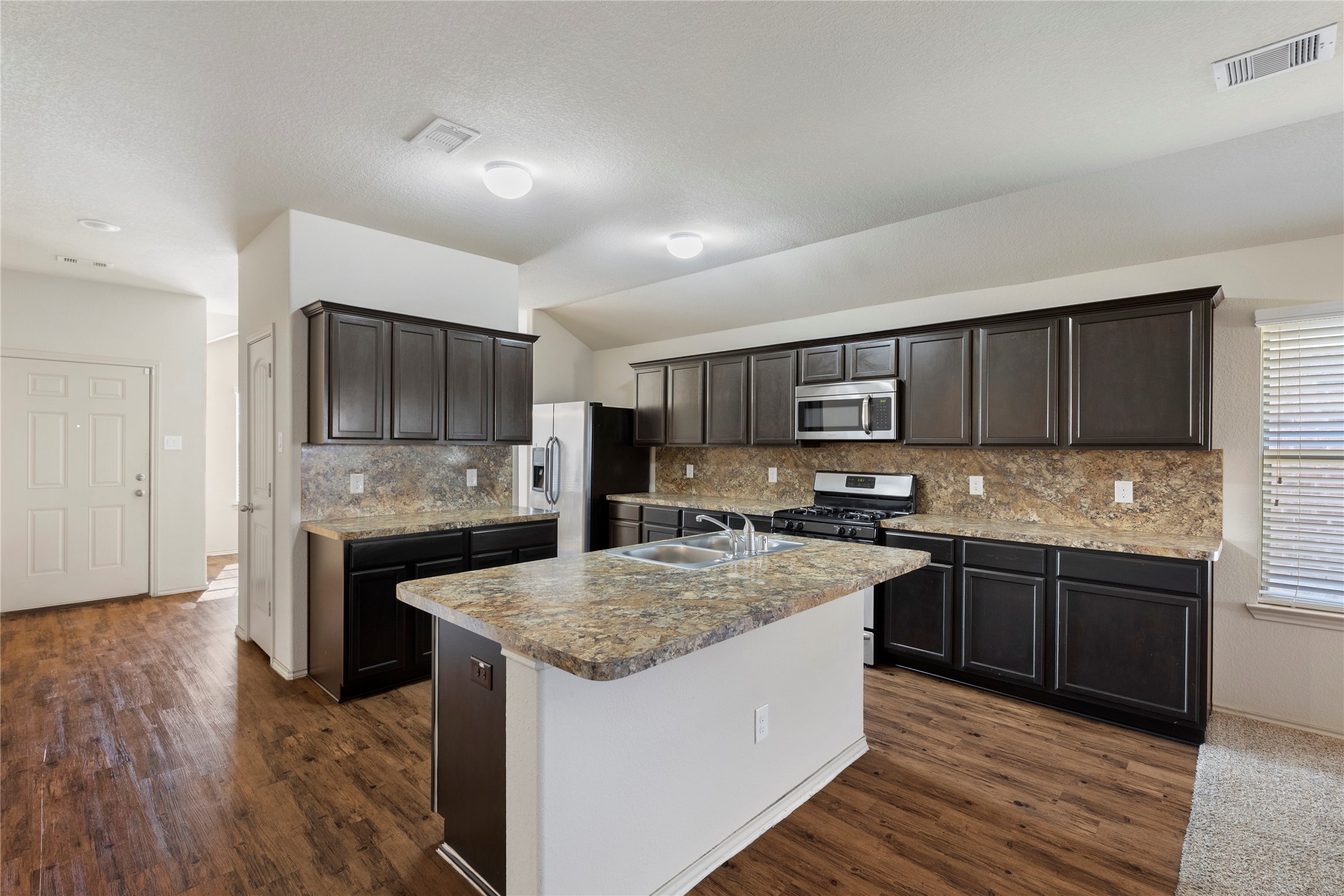 24407 Pigeon Berry Drive Spring, TX 77373 - Photo 11 of 34 a kitchen with stainless steel appliances granite countertop a sink stove and refrigerator