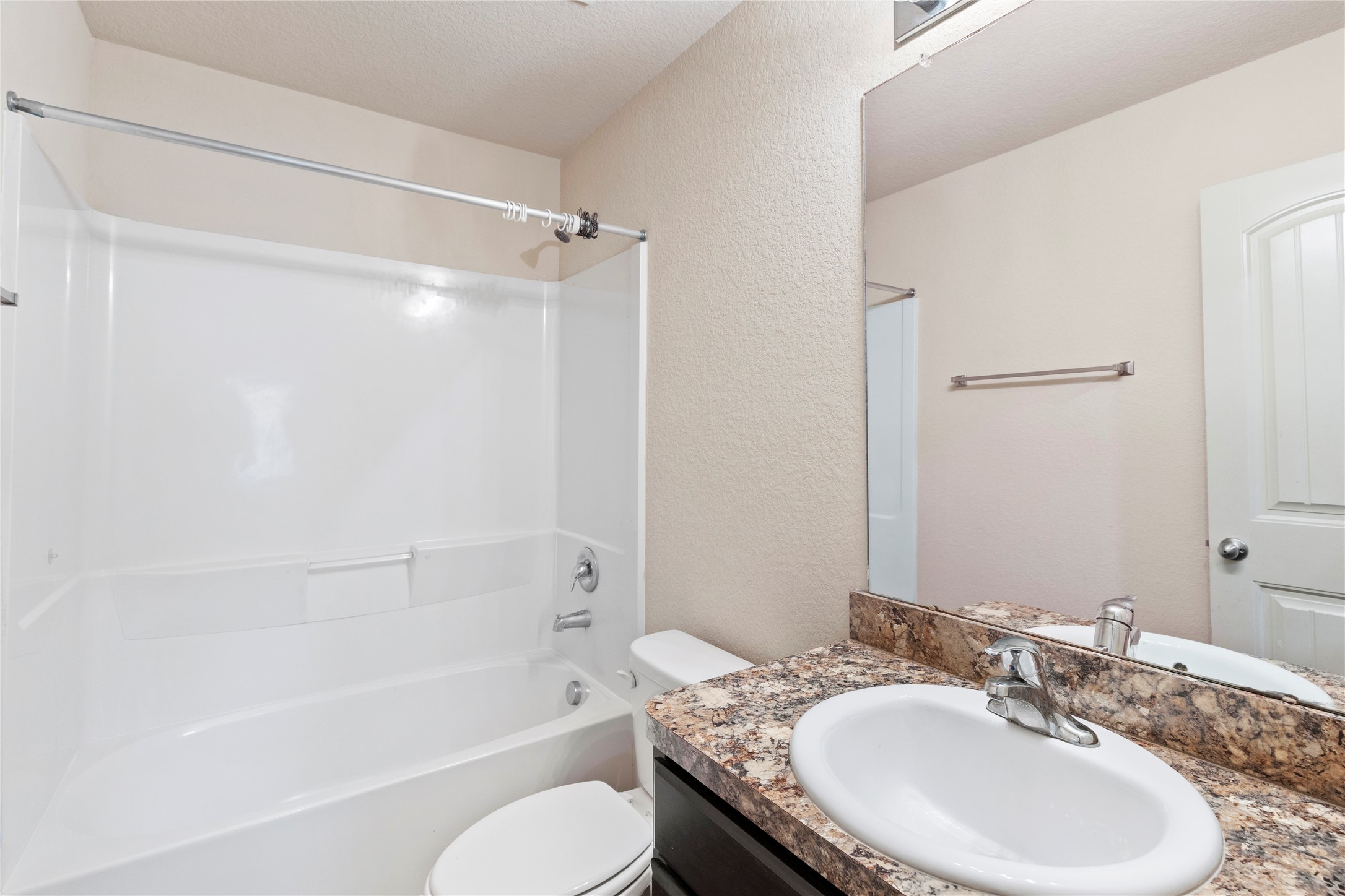 24407 Pigeon Berry Drive Spring, TX 77373 - Photo 26 of 34 a bathroom with a granite countertop sink toilet and shower