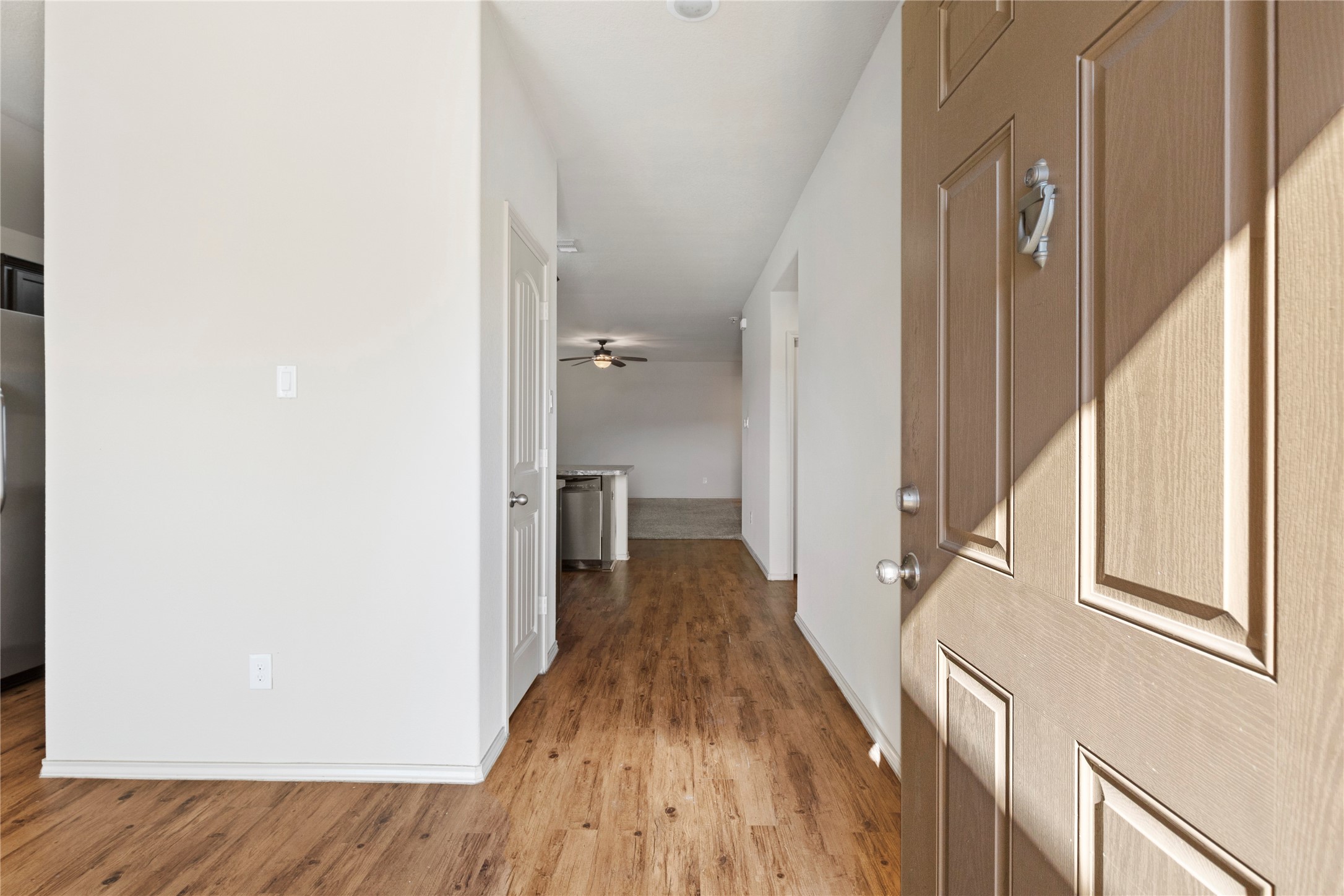 24407 Pigeon Berry Drive Spring, TX 77373 - Photo 3 of 34 a view of a hallway with wooden floor and staircase