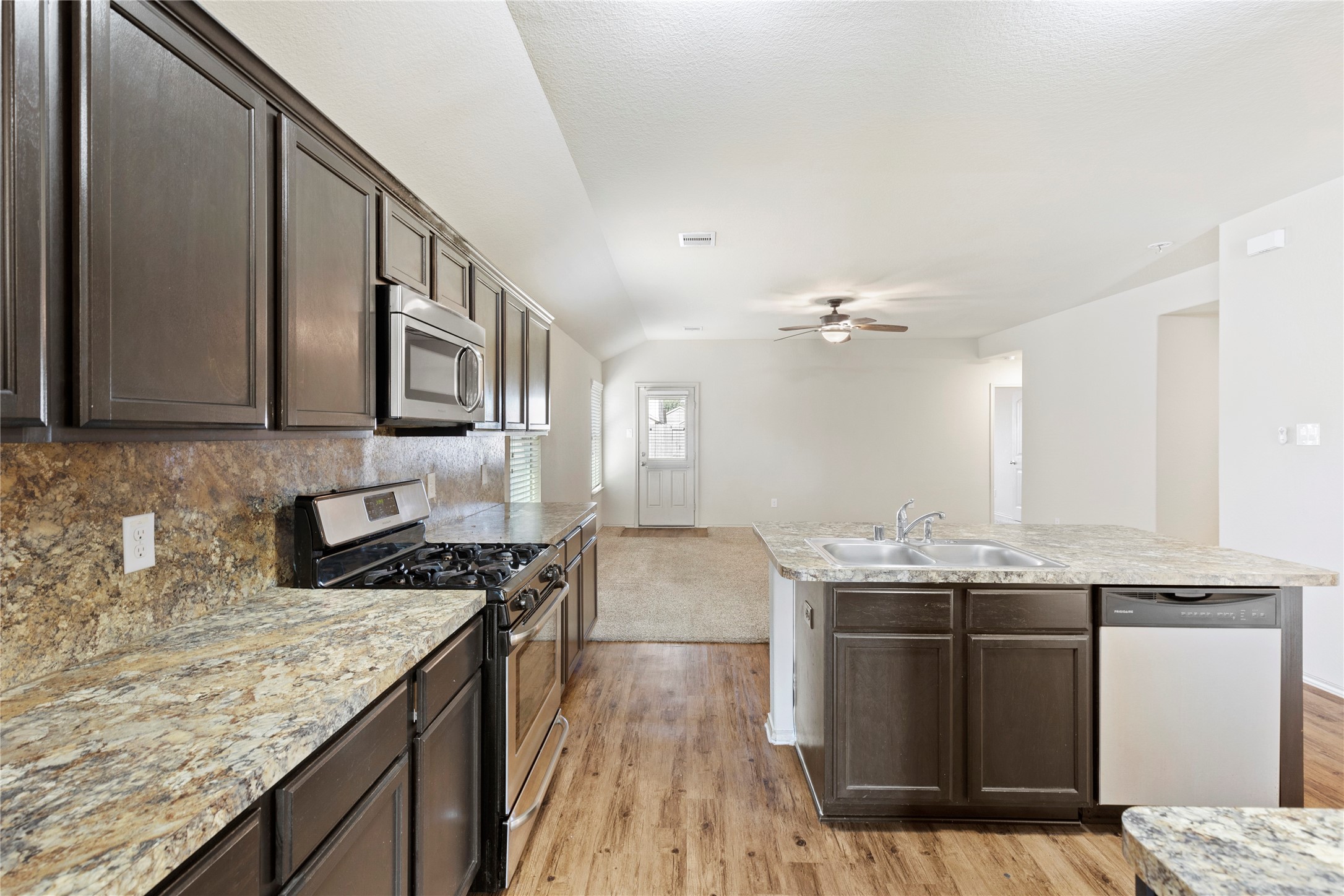 24407 Pigeon Berry Drive Spring, TX 77373 - Photo 7 of 34 a kitchen with stainless steel appliances granite countertop a sink stove and refrigerator