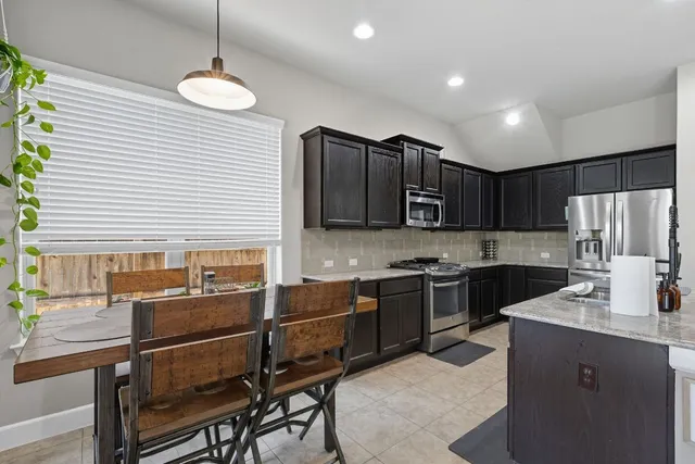 a kitchen with stainless steel appliances granite countertop a sink and stove