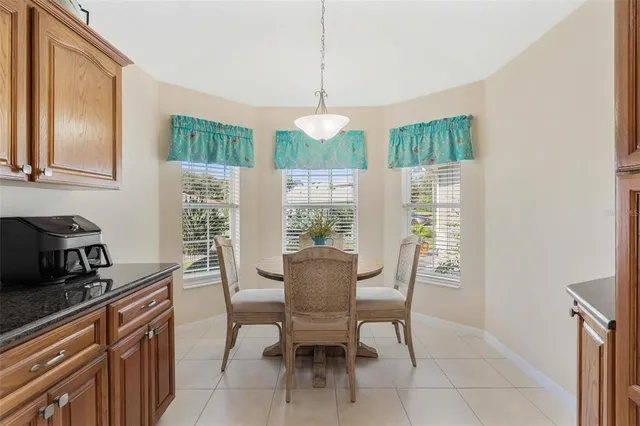 a dining room with furniture a chandelier and window