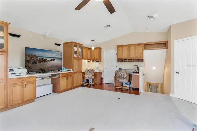 a kitchen view with furniture a counter top space and stainless steel appliances