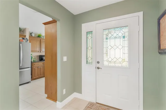 a bathroom with a refrigerator and mirror