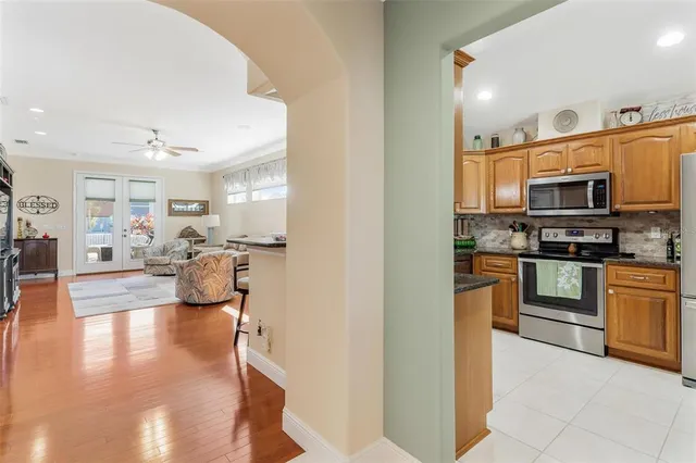 a kitchen with stainless steel appliances granite countertop a refrigerator stove and sink