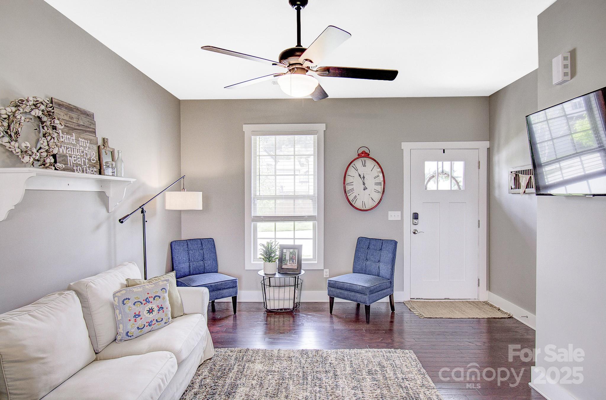 689 Cardwell Lane Fletcher, NC 28732 - Photo 11 of 39 a living room with furniture a clock on wall and a window