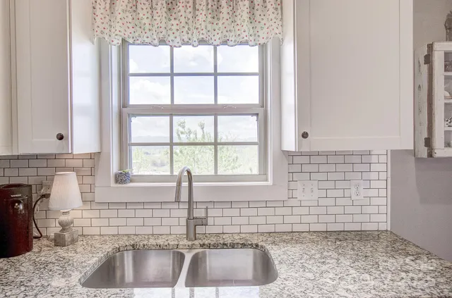 a kitchen with a sink a faucet and a window
