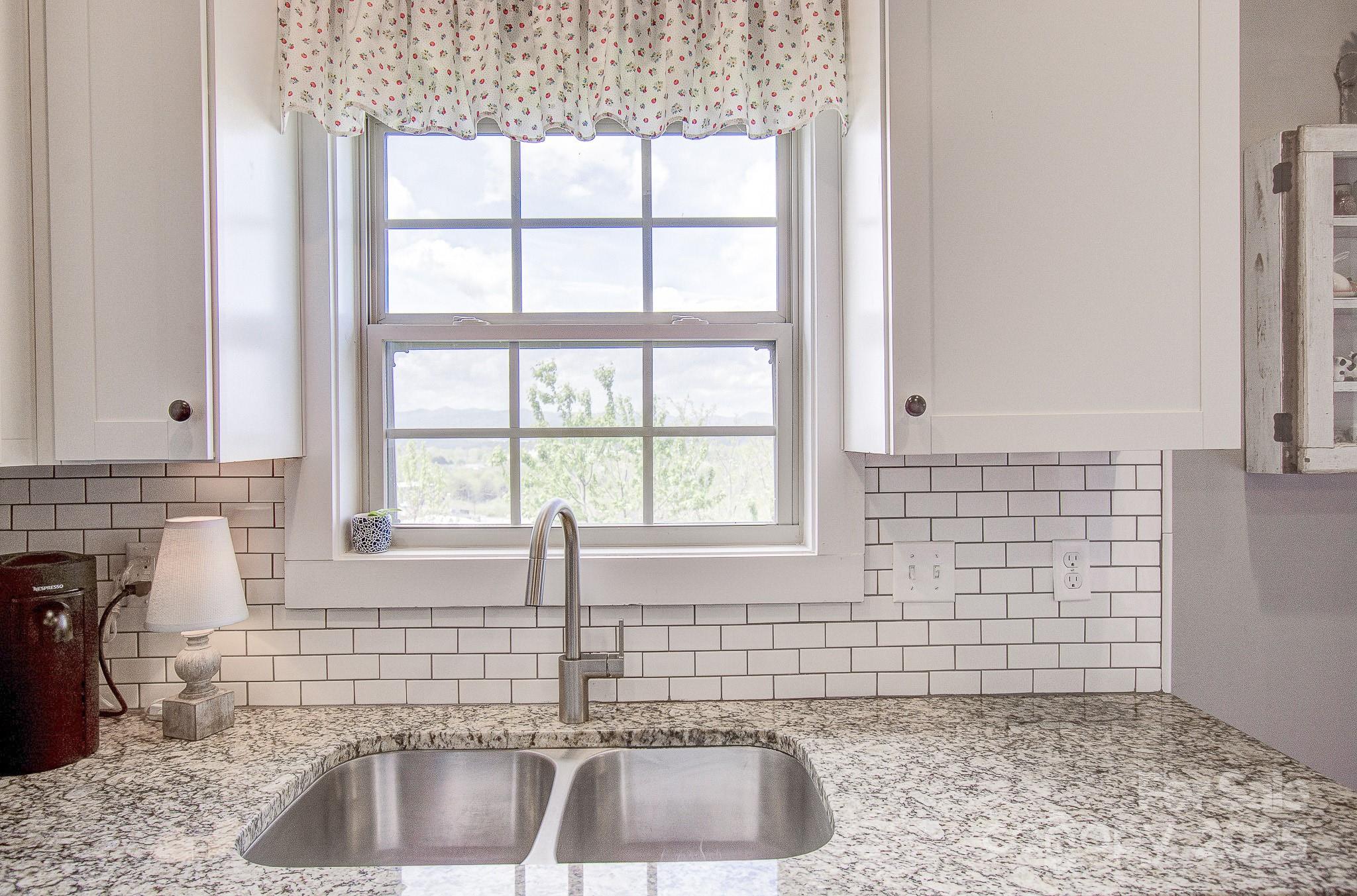 689 Cardwell Lane Fletcher, NC 28732 - Photo 12 of 39 a kitchen with a sink a faucet and a window