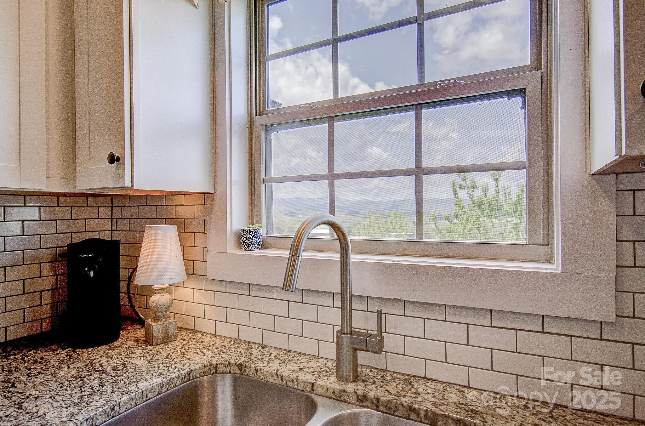 689 Cardwell Lane Fletcher, NC 28732 - Photo 13 of 39 a view of a kitchen with a sink and a large window