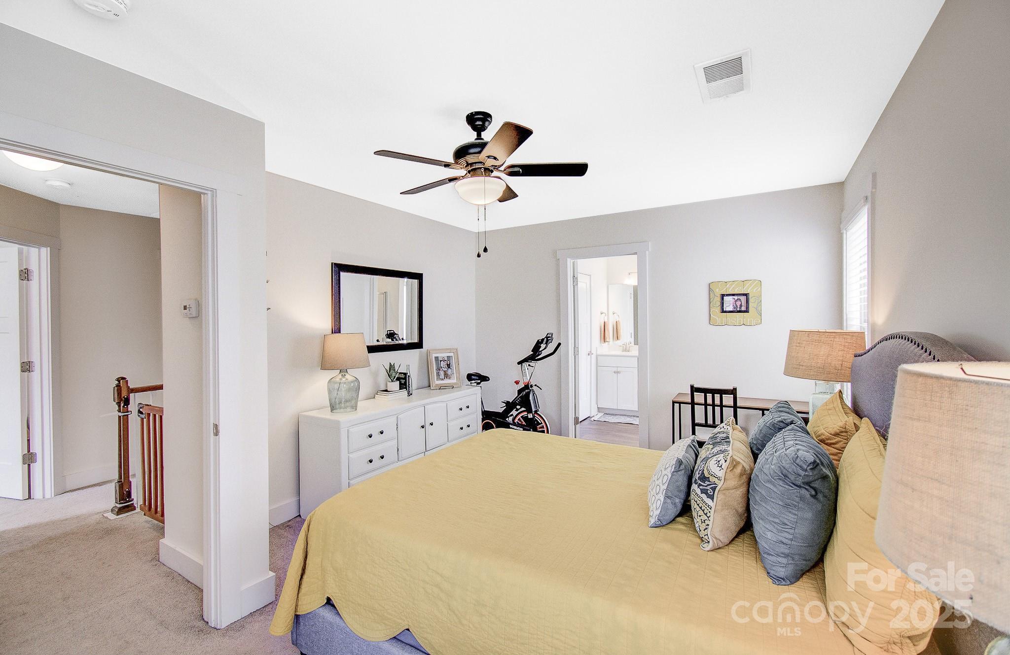 689 Cardwell Lane Fletcher, NC 28732 - Photo 21 of 39 a bedroom with a bed and a chandelier